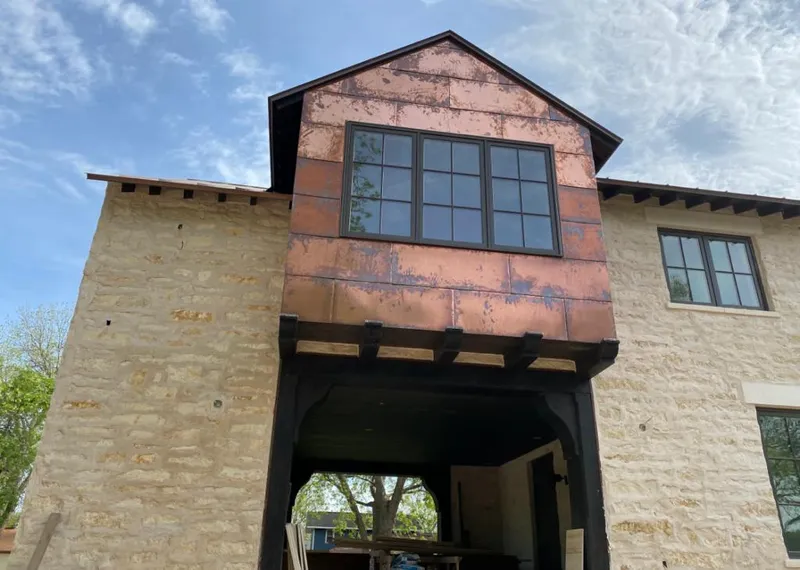 Copper metal panel facade on a stone building for Skylight Installation in Ville Platte